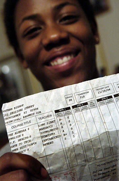 PROVIDENCE, RHODE ISLAND--JANUARY 24, 2005--Julius Searight <cq> , 15, holds his report card from his first semester in the eighth grade at Nathan Bishop Middle School in Providence, RI, where Julius currently lives with his adopted parents. It was almost
